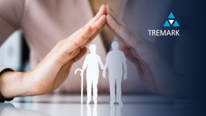 hands covering two cardboard cut-outs of pensioners